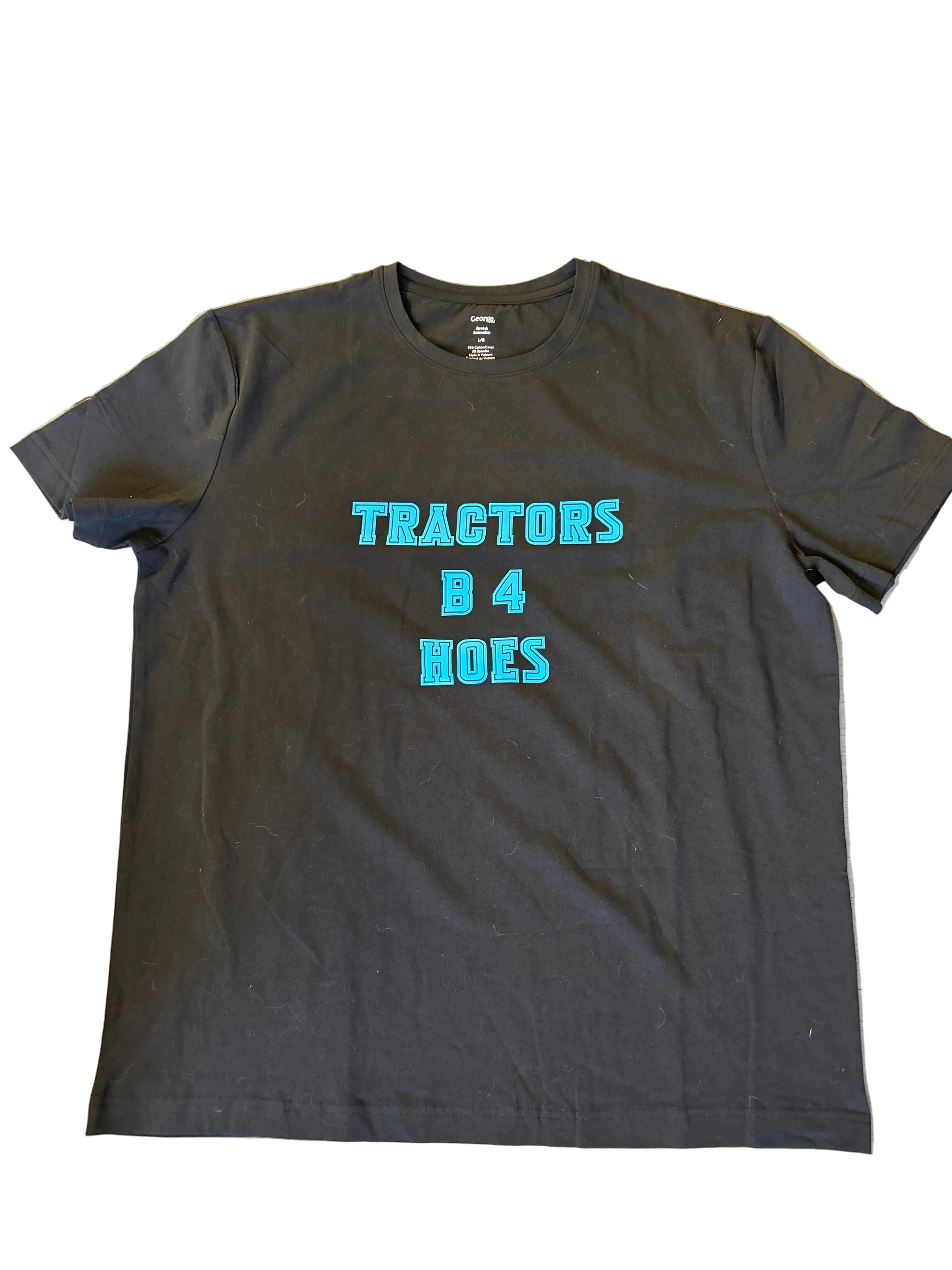 Black t-shirt with blue text on a light gray background